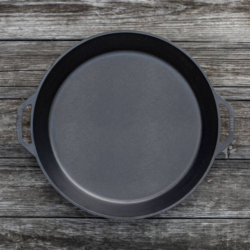 Handcrafted cast iron skillet with two loop handles, designed for large-scale cooking, featured in Kitchen & Food, Cookware, Cast Iron, USA Made, and Best Sellers collections.