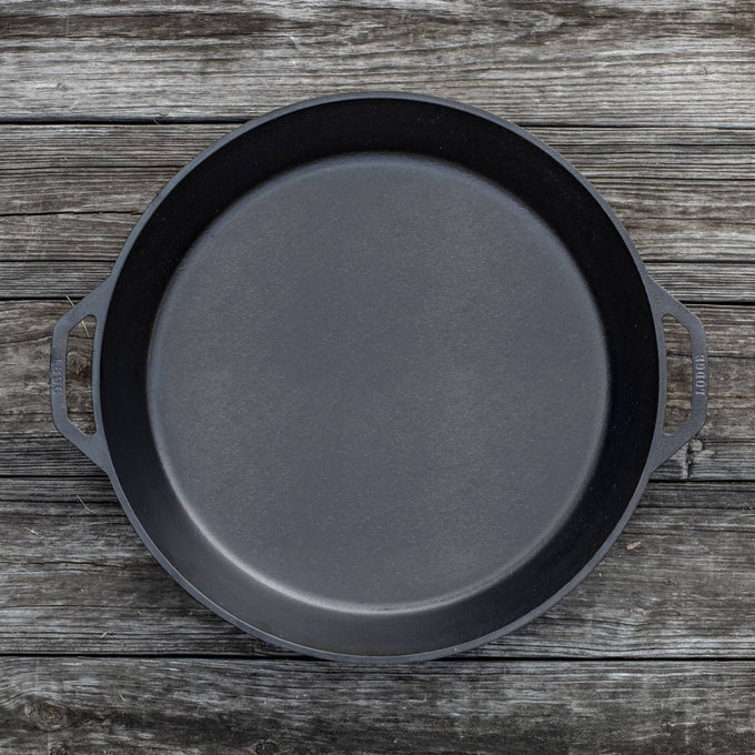 Handcrafted cast iron skillet with two loop handles, designed for large-scale cooking, featured in Kitchen & Food, Cookware, Cast Iron, USA Made, and Best Sellers collections.