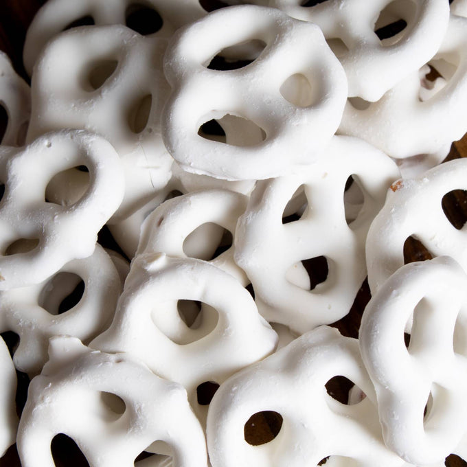 Close-up of handcrafted mini pretzels generously coated in white chocolate, a USA made snack perfect for Kitchen & Food, Food, Snacks and Sweets, Candy, Best Sellers, and Promo Eligible collections.