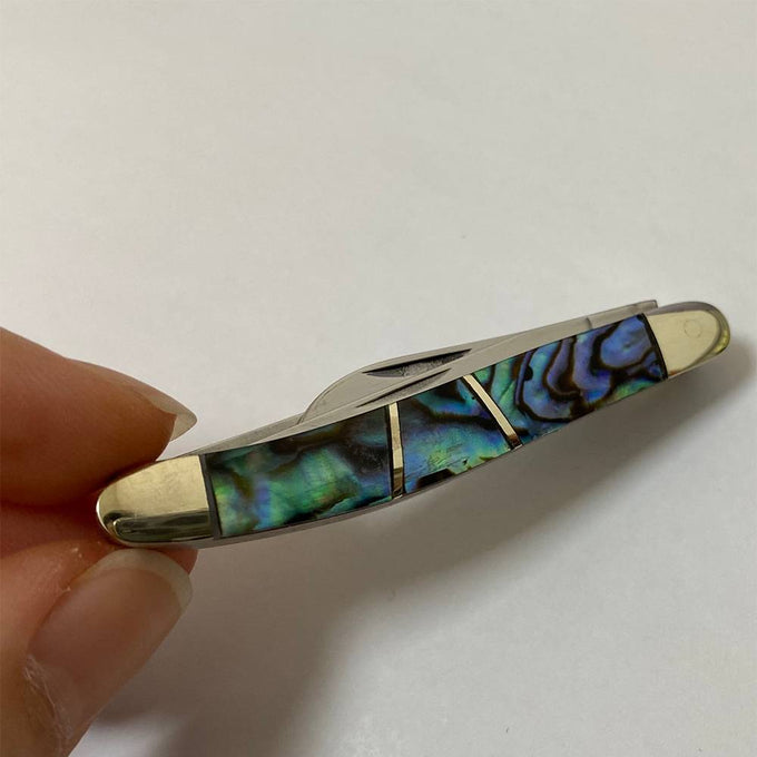 Compact handcrafted small dress knife featuring iridescent abalone shell handle with smooth brass terminals and stainless steel blades, ideal for Pocket Knives and Traditional Pocket Knives collections.