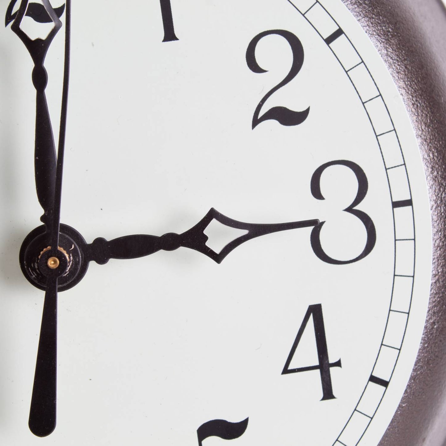 Close-up view of a handcrafted cast iron skillet clock face with elegant black hands and numerals on a light green undertone, made in USA, featured in Home & Decor and Cast Iron collections.