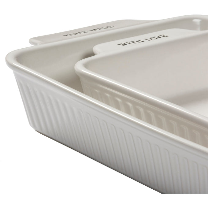 Pair of handcrafted cream-colored stoneware baking dishes with ribbed sides and engraved text, perfect for Kitchen & Food, Cookware, Baking Supplies, and Best Sellers collections.