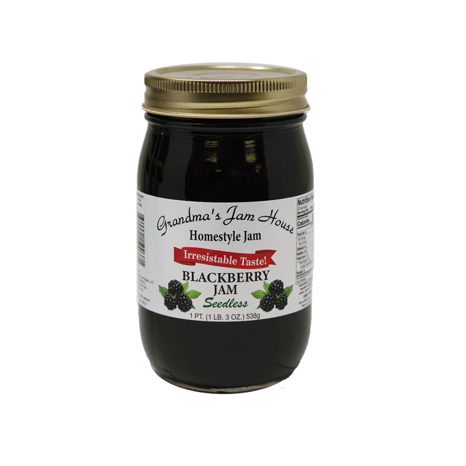 Glass jar of handcrafted seedless blackberry jam with gold lid and white label featuring blackberry illustrations, included in Kitchen & Food, Pantry, Peanut Butter & Jellies, USA Made, Best Sellers, and Promo Eligible collections.