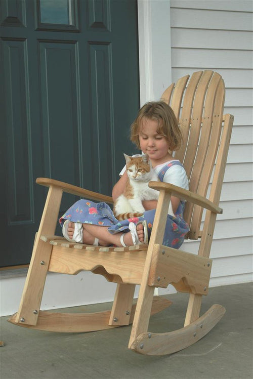 Handcrafted durable cypress rocking chair made in USA with slatted back, shown with child holding a cat on front porch, ideal for Home & Decor, Indoor and Outdoor Furniture collections.