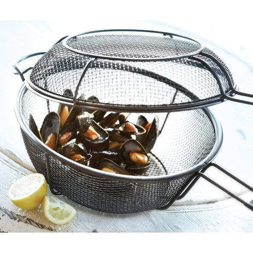 Metal mesh outdoor grill basket and skillet with handle, shown filled with cooked mussels and lemon wedges, designed for versatile grilling and smoky flavor infusion in cookware and grilling collections.