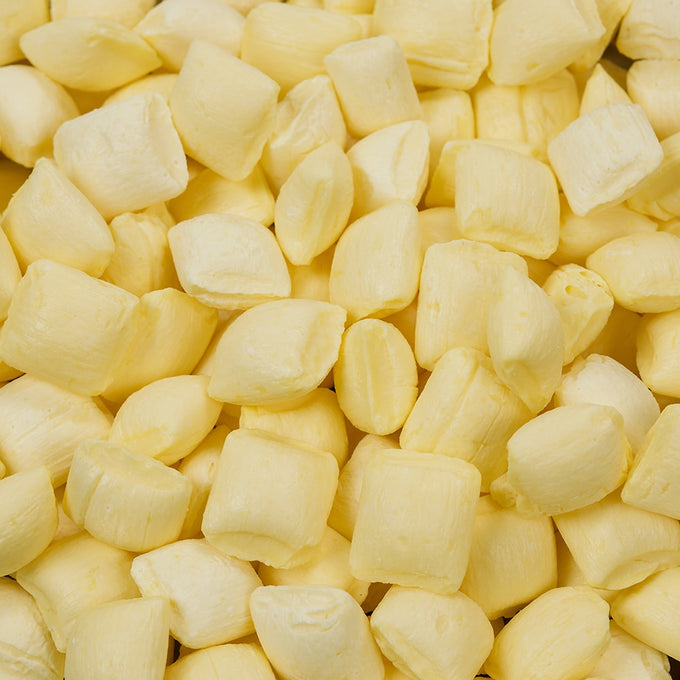 Close-up of pale yellow buttermint candies with a smooth, rich texture and buttery mint flavor, handcrafted in the USA, featured in Kitchen & Food, Snacks and Sweets, Candy, USA Made, and Best Sellers collections.