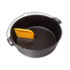 Yellow pan scraper tool resting inside a black cast iron Dutch oven, designed for easy cleaning of cookware, featured in Kitchen & Food, Cookware, Cast Iron, and Best Sellers collections.
