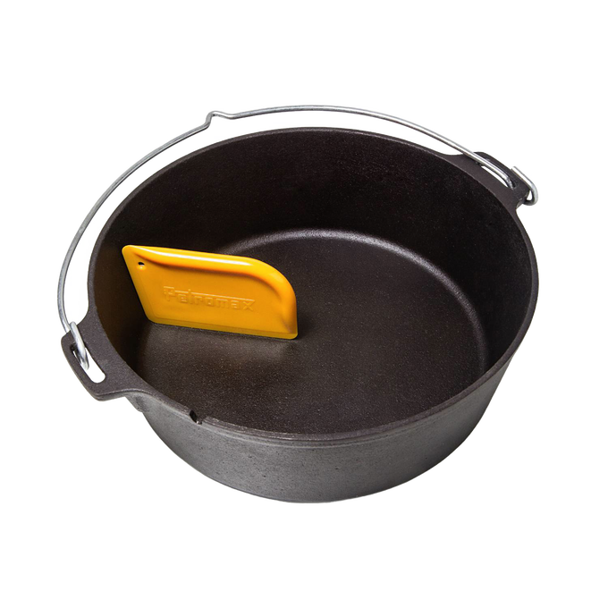 Yellow pan scraper tool resting inside a black cast iron Dutch oven, designed for easy cleaning of cookware, featured in Kitchen & Food, Cookware, Cast Iron, and Best Sellers collections.