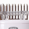 Close-up of stainless steel blades set in a clear protective cover on a white handheld meat tenderizer, part of Kitchen & Food, Specialty Equipment, and Butchering Supplies collections.