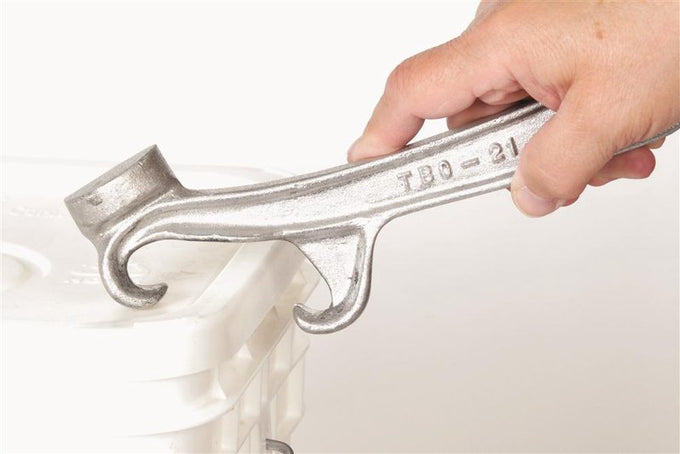 Handcrafted metal opener tool being used to pry open a plastic bucket lid, ideal for Farm, Garden & Tool, Hand Tools and Hardware, Kitchen & Food, and Best Sellers collections.