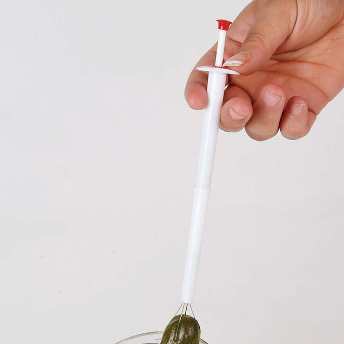 Handheld pickle picker with plastic handle and metal prongs lifting a pickle from a jar, perfect for Kitchen & Food, Kitchen Gadgets, Kitchen Accessories, Best Sellers, and Promo Eligible collections.