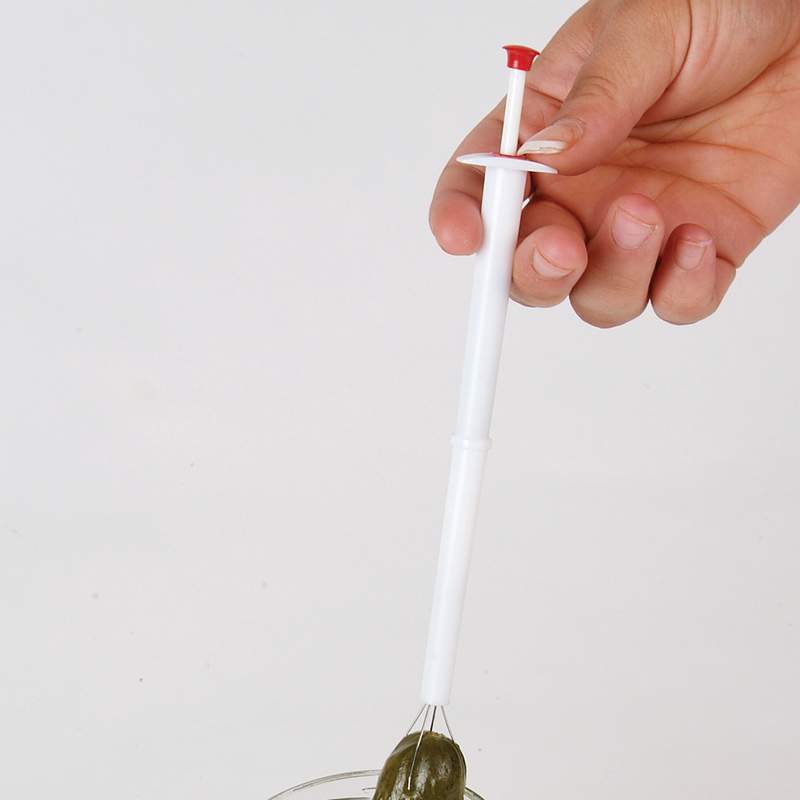 Handheld pickle picker with plastic handle and metal prongs lifting a pickle from a jar, perfect for Kitchen & Food, Kitchen Gadgets, Kitchen Accessories, Best Sellers, and Promo Eligible collections.