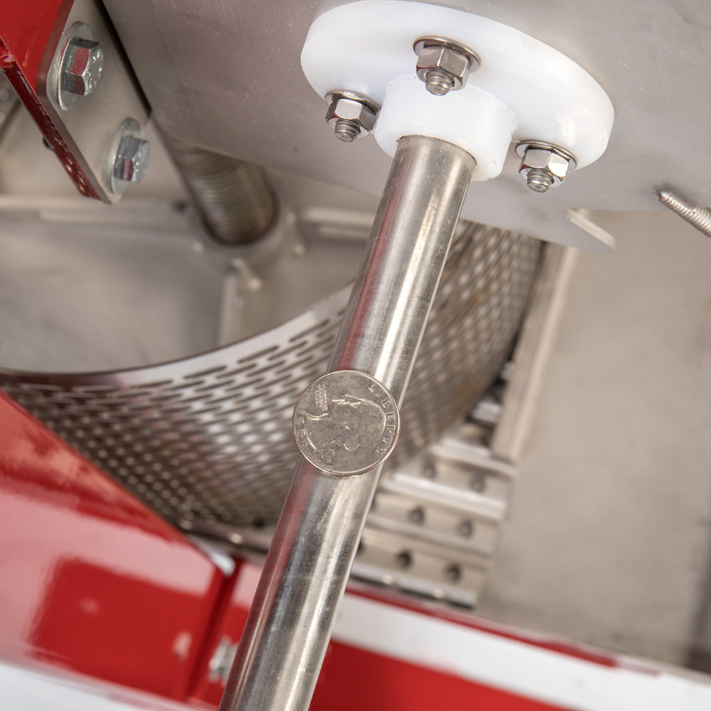 Close-up of the stainless steel pressing mechanism on a handcrafted cider press with sturdy bolts and a hygienic design, ideal for orchard and fruit pressing use.