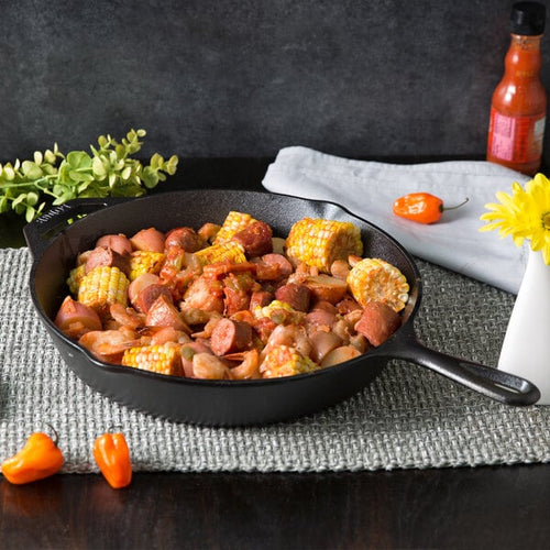 Handcrafted Lodge Classic Cast Iron Skillet filled with cooked sausage, vegetables, and corn on the cob, showcasing exceptional heat retention for Kitchen & Food, Cookware, Cast Iron, Best Sellers, Promo Eligible collections.