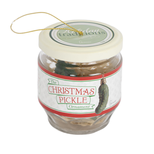 Clear glass jar with a cream lid containing a green pickle ornament with a gold hanging string, a handcrafted holiday decor item from Home & Decor and Best Sellers collections.