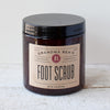 Amber jar of handcrafted foot scrub with a simple beige label, made in USA and featured in Health & Wellness, Balms, Creams and Lotions, Best Sellers, and Promo Eligible collections.