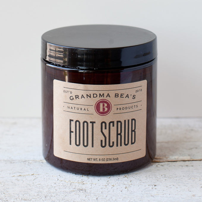 Amber jar of handcrafted foot scrub with a simple beige label, made in USA and featured in Health & Wellness, Balms, Creams and Lotions, Best Sellers, and Promo Eligible collections.