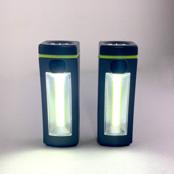 Two compact LED flashlights with bright white light, featuring a green accent stripe, ideal for camping, emergency supplies, and battery-powered outdoor lighting collections.