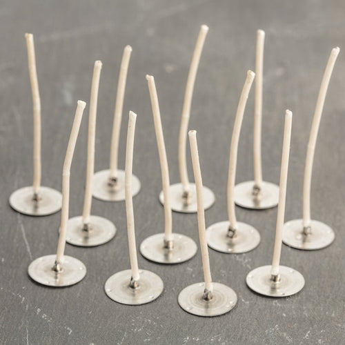 Set of pre-waxed paper wick tabs with metal bases, handcrafted in the USA for use in votive and small container candles, featured in Candlemaking Supplies and Lamps & Lighting collections.