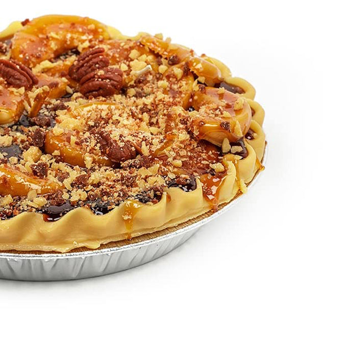 Close-up of a handcrafted peach-scented dessert candle with a realistic golden crust, nut topping, and crumble details, made in USA, perfect for Home & Decor and Apple Harvest Supplies collections.