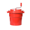 Bright red hand-powered spinner with a crank handle and secure lid, designed for fast clothes wringing and dual use in laundry and home decor collections.