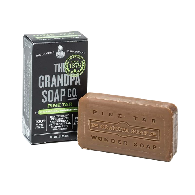 Rustic handcrafted pine tar soap bar with embossed branding, made in USA, ideal for Grooming and Personal Hygiene, Health & Wellness, and Soaps collections.