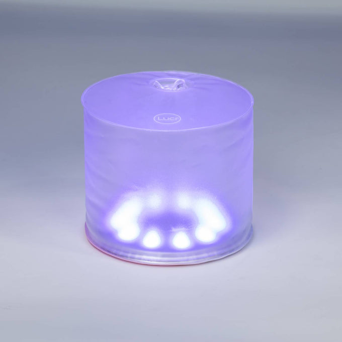 Inflatable rechargeable solar LED lantern glowing softly in purple, designed for versatile outdoor use in camping, emergency supplies, and garden lighting collections.