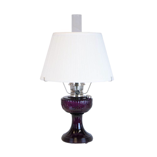 Handcrafted amethyst glass oil lamp with a vintage-inspired design, topped with a white pleated cloth shade and tripod base, featured in Lamps & Lighting and Best Sellers collections.