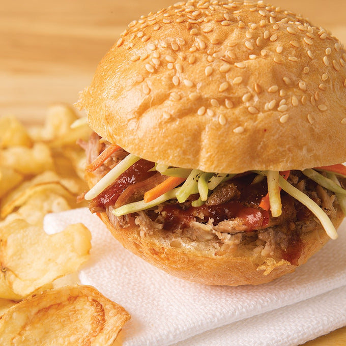 Handcrafted sandwich with tender pulled pork, barbecue sauce, and fresh coleslaw on a sesame seed bun, served with a side of crispy potato chips, ideal for Kitchen & Food, Farm, Garden & Tool, Emergency Supplies, Meats, Food, Best Sellers, and Promo Eligible collections.