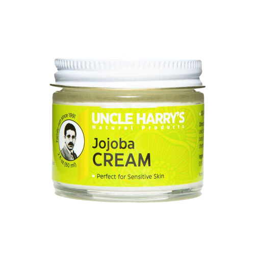 Small glass jar with white lid containing handcrafted jojoba cream moisturizer for sensitive skin, labeled with bright yellow USA Made Health & Wellness branding.