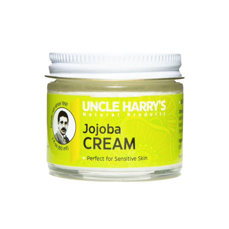 Small glass jar with white lid containing handcrafted jojoba cream moisturizer for sensitive skin, labeled with bright yellow USA Made Health & Wellness branding.