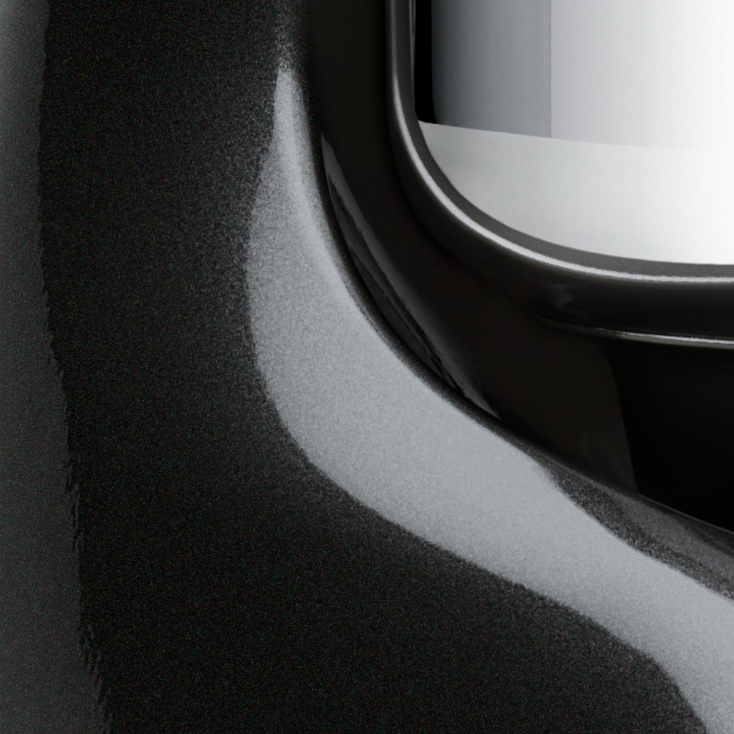 Close-up detail of a glossy black enamel surface with a polished stainless steel bowl edge, highlighting the craftsmanship of a durable kitchen mixer for Baking Supplies and Kitchen Gadgets collections.