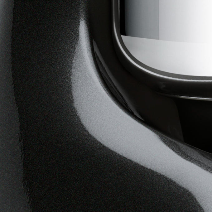 Close-up detail of a glossy black enamel surface with a polished stainless steel bowl edge, highlighting the craftsmanship of a durable kitchen mixer for Baking Supplies and Kitchen Gadgets collections.
