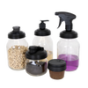 Set of six clear glass jars with various black reusable lids including flip-top, pump, spray, and screw-top styles suitable for eco-friendly household use in Home & Decor and Household Helpers collections.