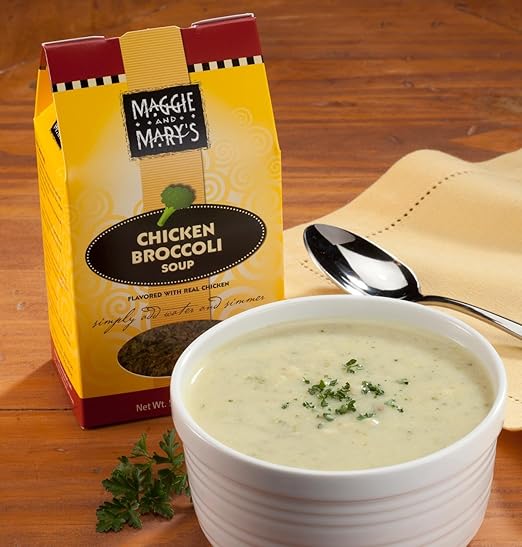 Creamy chicken broccoli soup garnished with fresh parsley in a white bowl next to handcrafted Maggie and Mary's Soup Mixes package, perfect for Kitchen & Food, Dry Goods and Mixes, Soups, USA Made, Best Sellers, Promo Eligible collections.