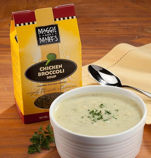 Creamy chicken broccoli soup garnished with fresh parsley in a white bowl next to handcrafted Maggie and Mary's Soup Mixes package, perfect for Kitchen & Food, Dry Goods and Mixes, Soups, USA Made, Best Sellers, Promo Eligible collections.