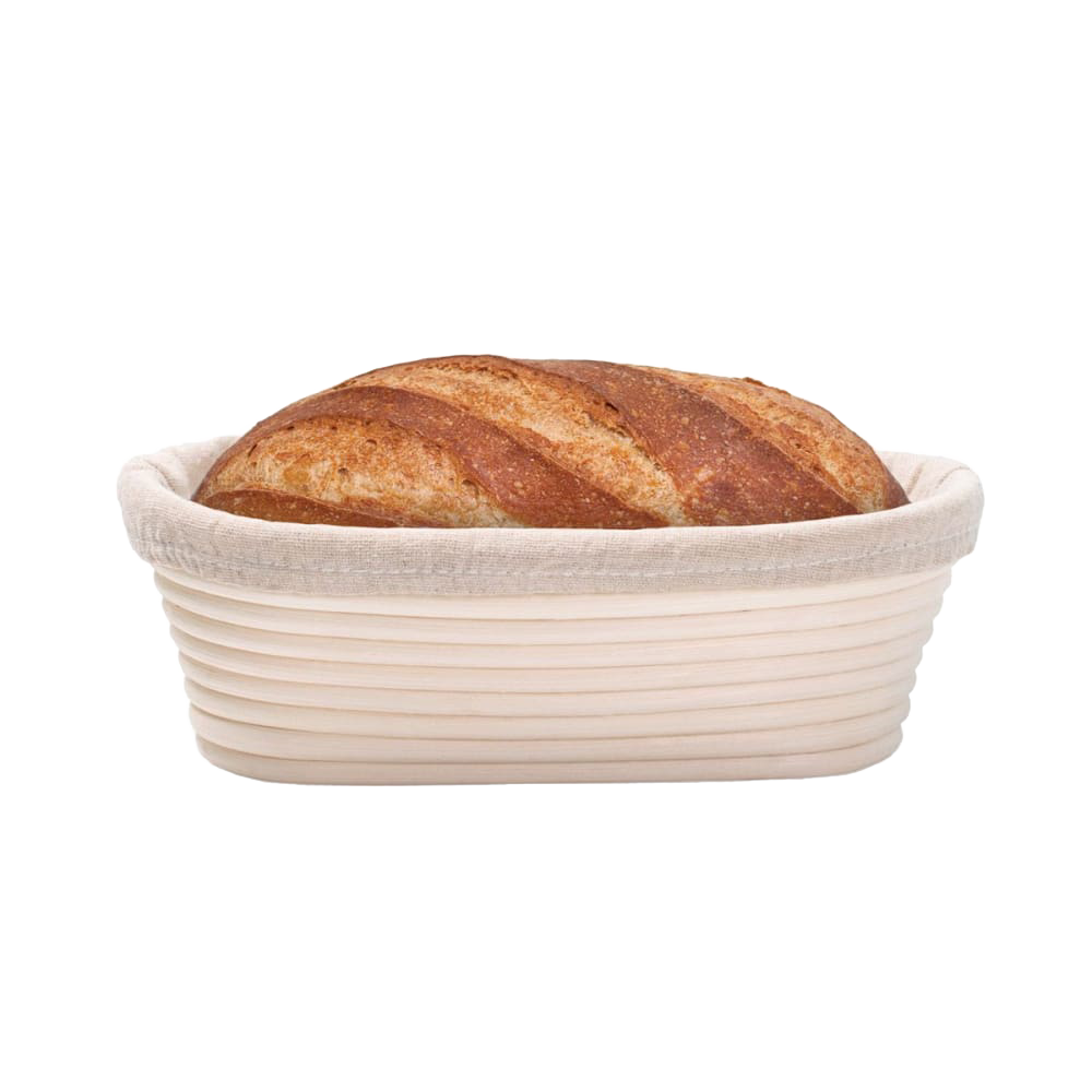 Handcrafted oval rattan bread proofing basket with a removable cloth liner holding a golden sourdough loaf, designed for even rising in Kitchen & Food, Baking Supplies, and Bread Making collections.