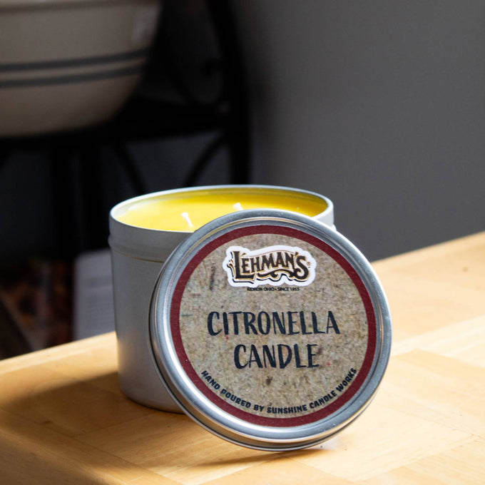 Handcrafted two-wick citronella candle with bright yellow wax in a lightweight metal tin, designed for outdoor use in camping, pest control, farm, garden, and lighting collections.