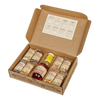 Open cardboard box containing eight small labeled bags of assorted handcrafted popcorn kernels, a bottle of Amish-made seasoning and a jar of syrup, suitable for Kitchen & Food, Snacks and Sweets, USA Made, Amish Made, and Best Sellers collections.