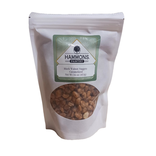 Resealable white pouch with caramelized black walnut nuggets visible through a clear window, featuring a green and white label, part of Kitchen & Food, Snacks and Sweets, Pantry, USA Made, and Best Sellers collections.
