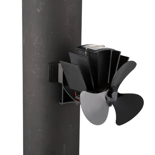 Black heat-powered stove fan with three broad blades and metal fins, designed to mount on a wood stove flue pipe, crafted to enhance warm air circulation in homes, featured in Hearth Accessories and Best Sellers collections.