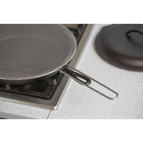 Stainless steel splatter screen with fine mesh and long handle placed on a gas burner, designed to keep cooking areas clean, featured in Kitchen & Food, Kitchen Gadgets, Cooking and Baking Helpers, Best Sellers, and Promo Eligible collections.