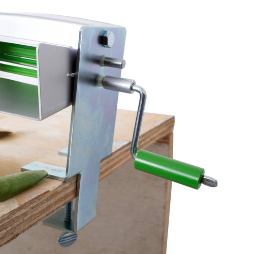 Compact metal pea sheller with green handle and clamp mounting to wooden surface, featuring tough nylon gear, suitable for shelling peas or beans in Kitchen & Food, Specialty Equipment, USA Made, and Peelers and Pitters collections.