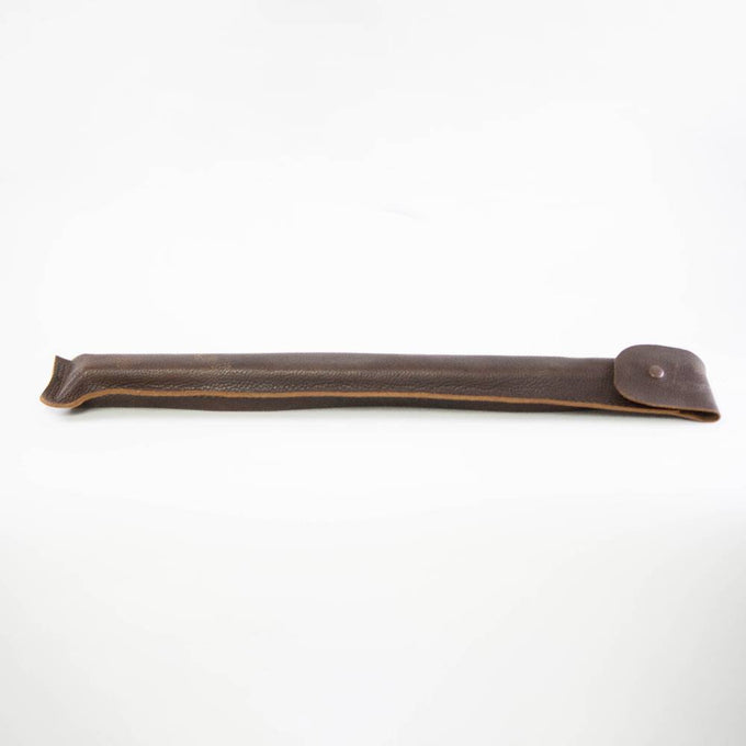 Handcrafted dark brown leather sheath with stitched edges and a button closure, designed to protect and carry woodcutting tools in farm, garden, and hauling collections.