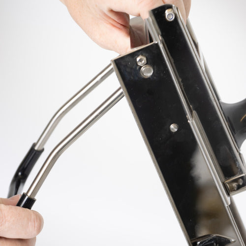 Close-up of hands adjusting the stainless steel frame on Lehman's Kitchen Mandoline Veggie Slicer, a handcrafted food prep tool featured in Kitchen & Food and Food Prep collections.