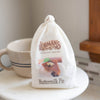 Soft white cloth drawstring pouch of handcrafted pie filling mix with vintage-style branding and buttermilk pie image, ideal for Kitchen & Food and Dry Goods collections.