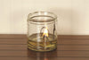 Handcrafted olive oil lamp with a flat wick burning brightly in a clear glass jar, ideal for Lamps & Lighting, USA Made, and Olive Oil Lamps collections.