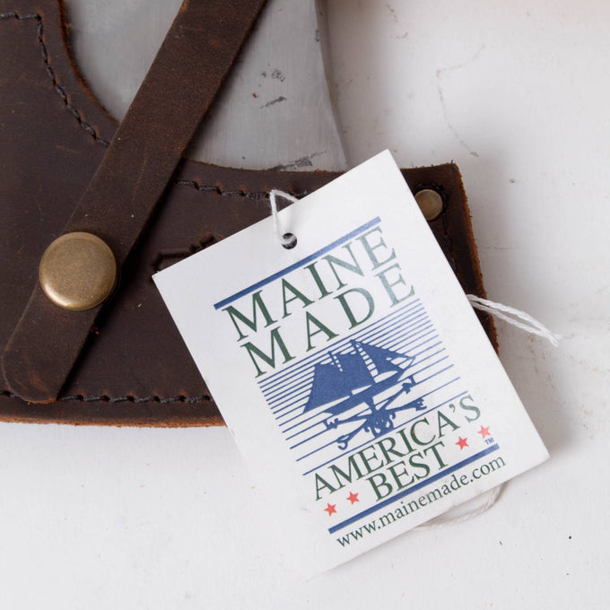 Close-up of a leather sheath with a metal snap button and attached Maine Made tag, highlighting American craftsmanship and quality standards in Farm, Garden & Tool and USA Made collections.