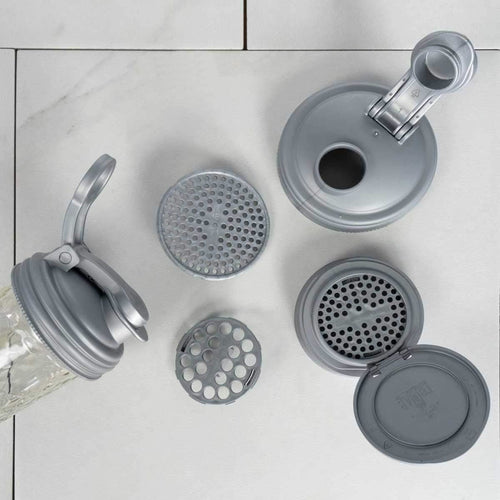 Six-piece set of gray reusable mason jar lids with pour and flip tops, including removable perforated inserts, designed as eco-friendly household helpers for Home & Decor and Best Sellers collections.