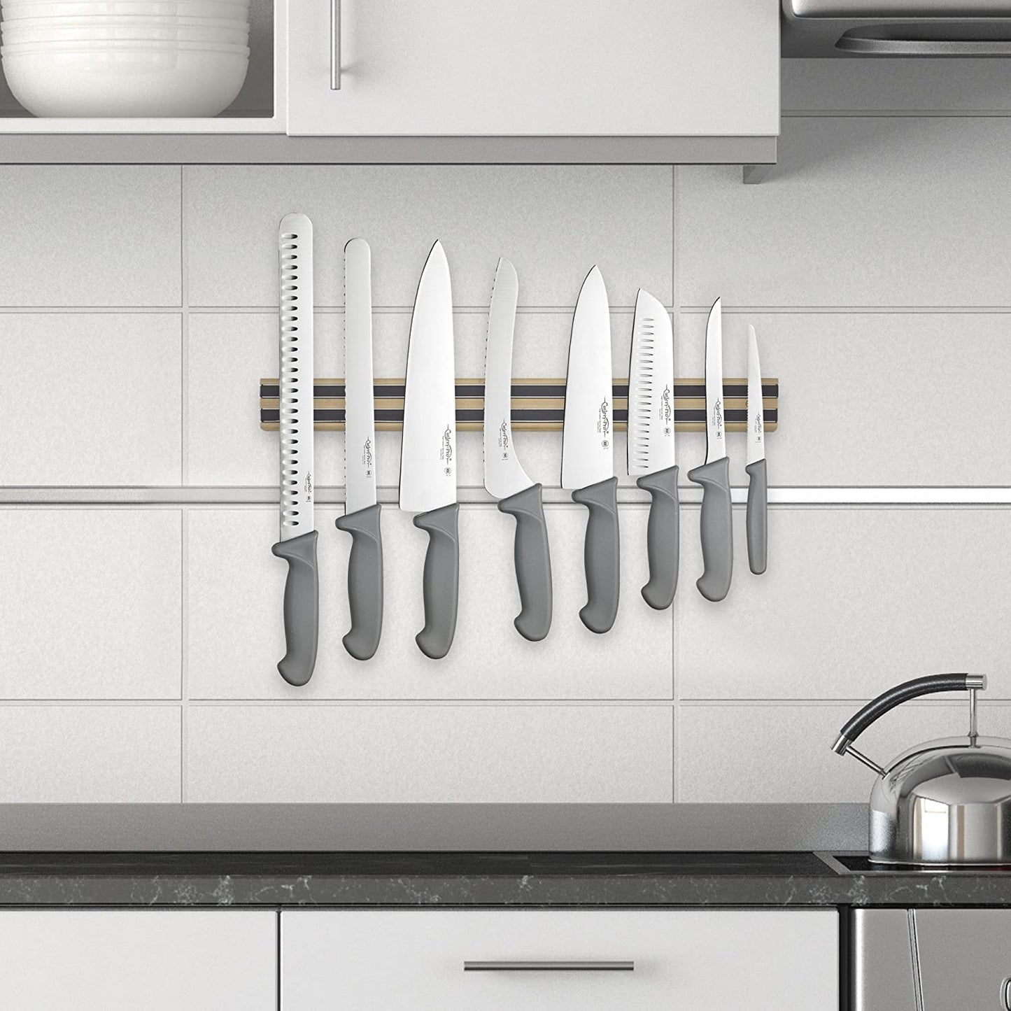 Handcrafted heavy-duty hardwood magnetic rack with dual strips securely holding a variety of kitchen knives with gray handles, ideal for Food Prep and Kitchen & Food collections.